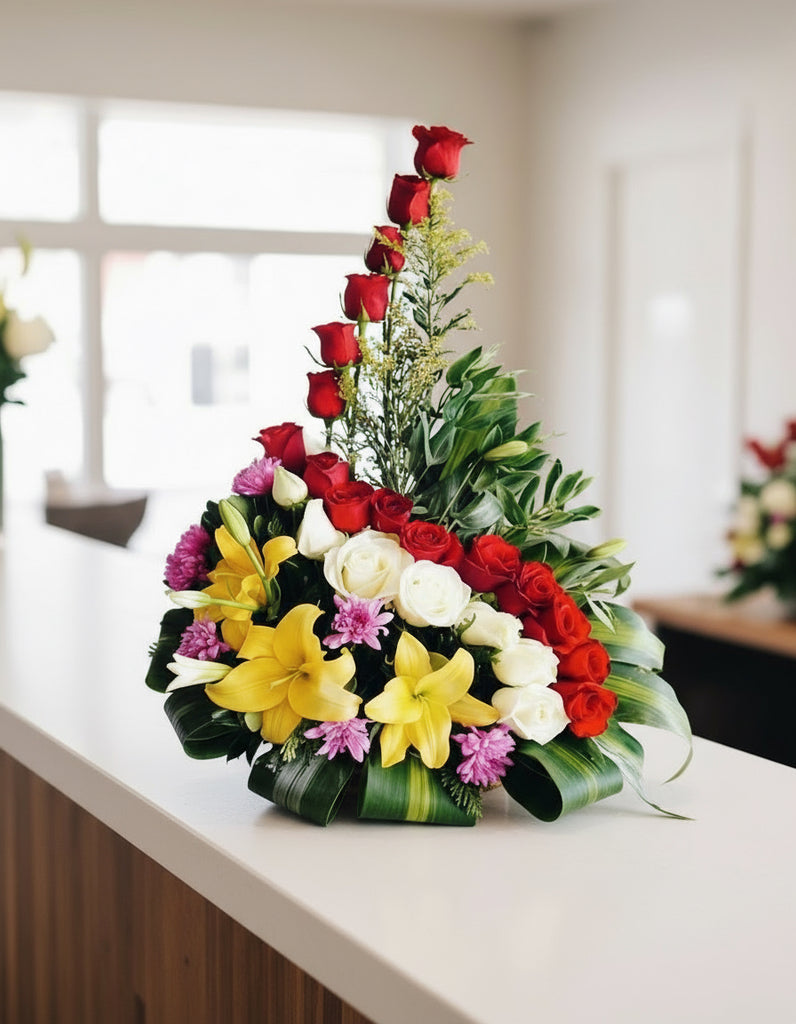 Bouquet of red roses, white roses and yellow lilies, with green leaves on a white background